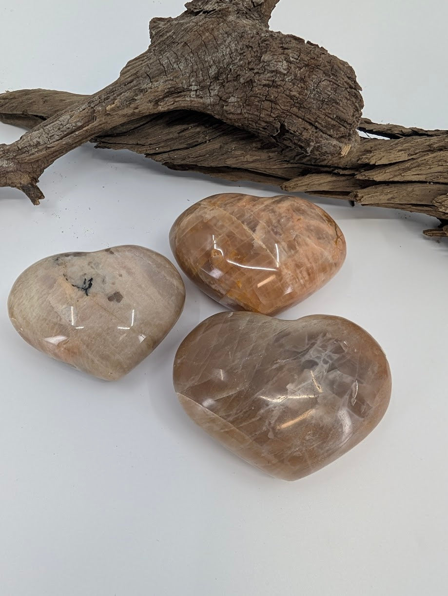 Trio of Cream Moonstone hearts showing soft beige color and sheen.