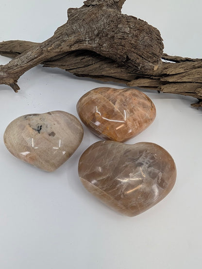 Trio of Cream Moonstone hearts showing soft beige color and sheen.