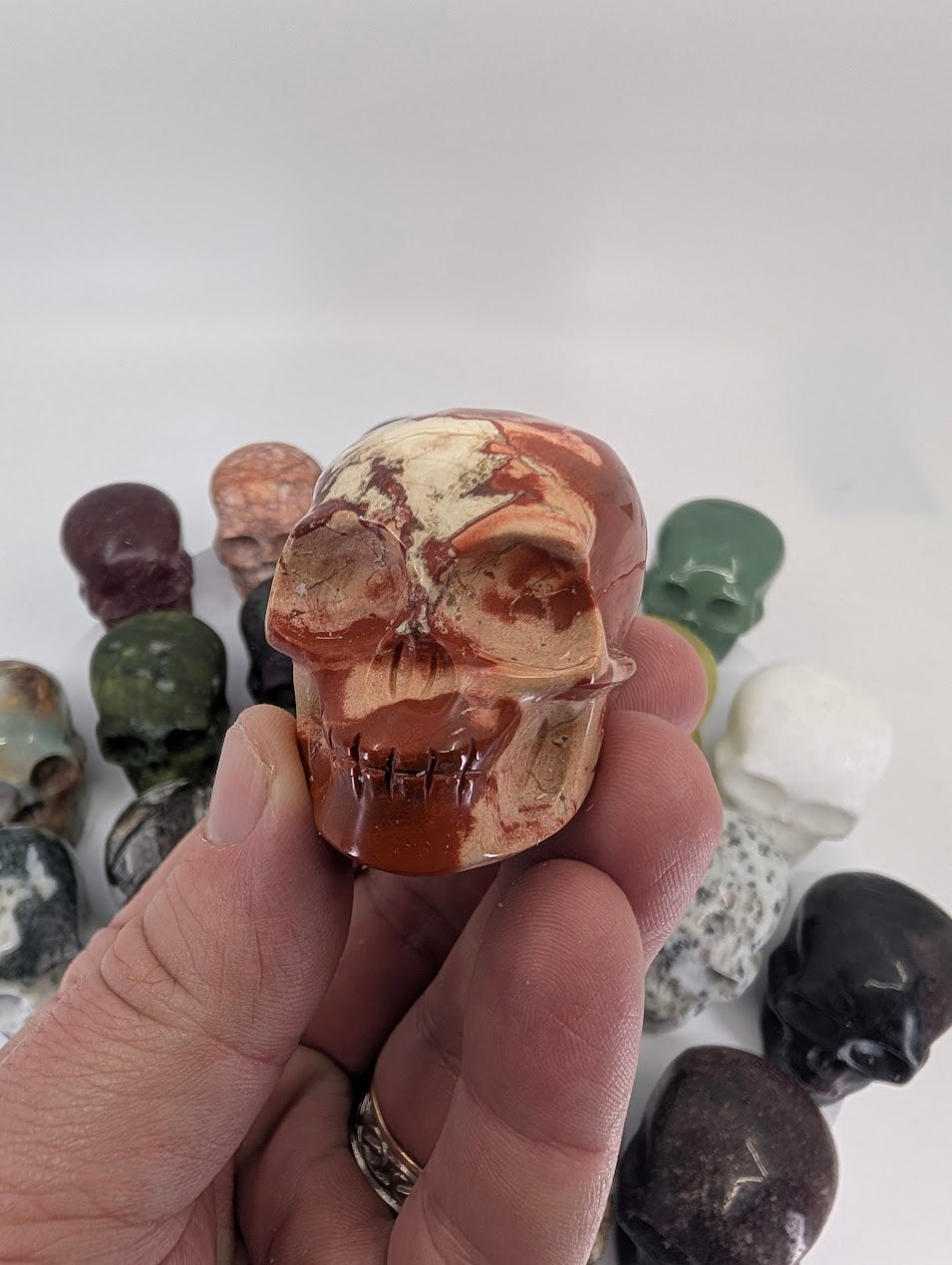 41mm crystal skull carvings – close-up group detail highlighting stone textures – Legacy Crystals and Minerals