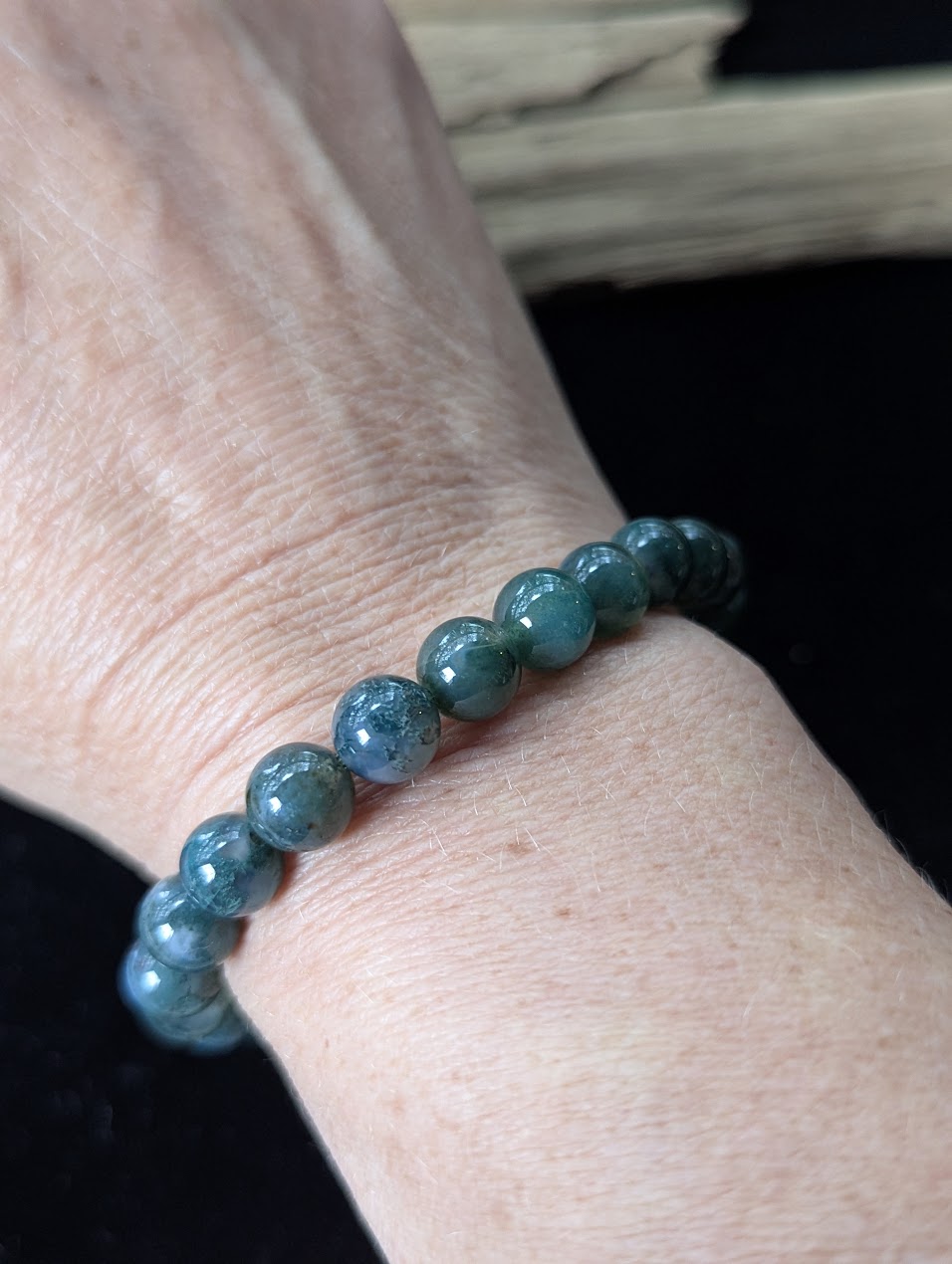 9mm Dark Moss Agate beaded bracelet styled on a wrist, showing comfortable fit and rich forest-green tones.