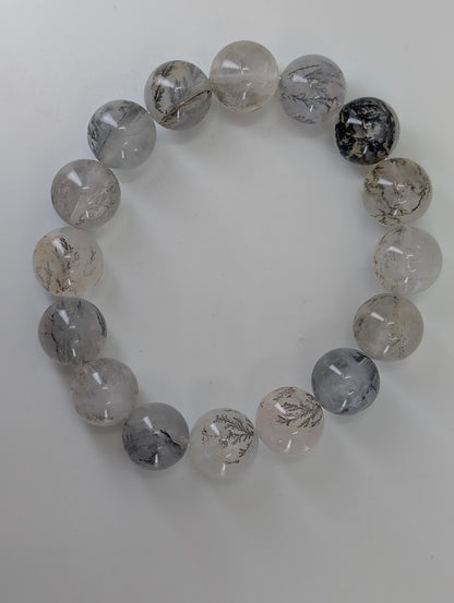 14mm dendritic quartz bracelet photographed from top view showing full bead patterning.