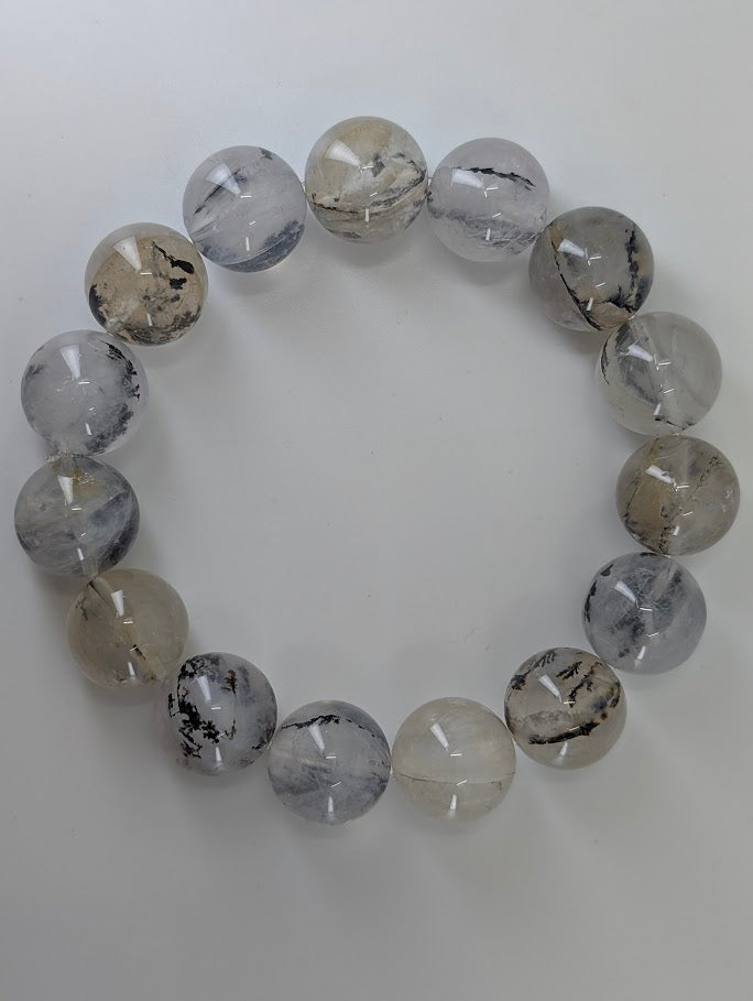 15mm dendritic quartz bracelet highlighting high-clarity beads with bold dendrite structures.