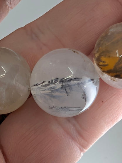16mm dendritic quartz bracelet showing natural manganese oxide inclusions and clear quartz beads.