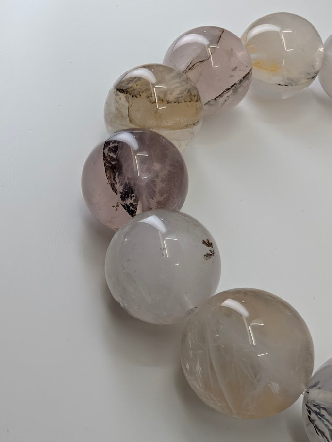 16mm dendritic quartz bracelet showing natural manganese oxide inclusions and clear quartz beads.