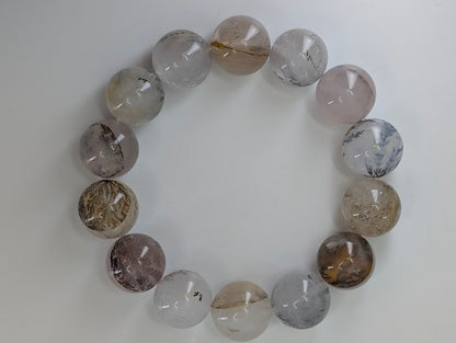 16mm dendritic quartz bracelet showing natural manganese oxide inclusions and clear quartz beads