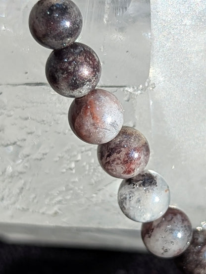 Macro close-up view of polished 4mm Dragon Bloodstone spheres, highlighting the vitreous surface luster and distinct structural color boundaries within the metamorphic jasper matrix.