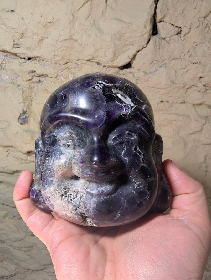 Dream Amethyst Laughing Buddha Head in hand for scale reference – 1.86 kg