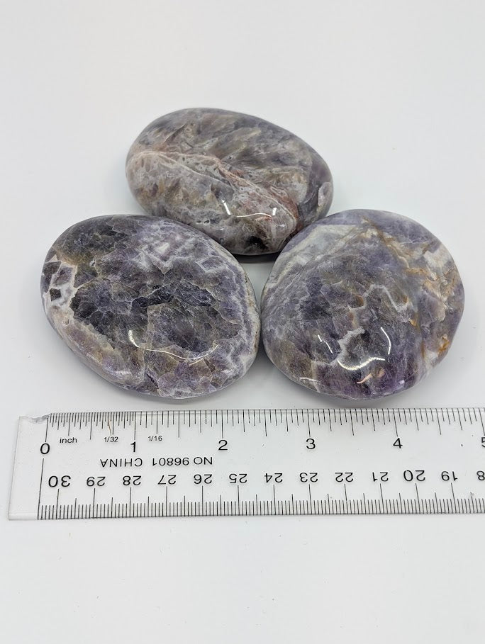 Dream Amethyst Palm Stones beside ruler for scale reference