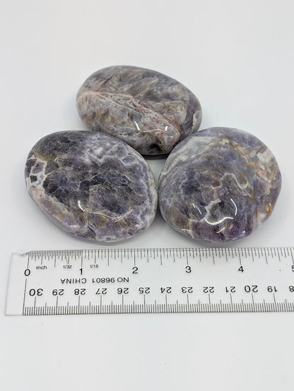 Dream Amethyst Palm Stones beside ruler for scale reference