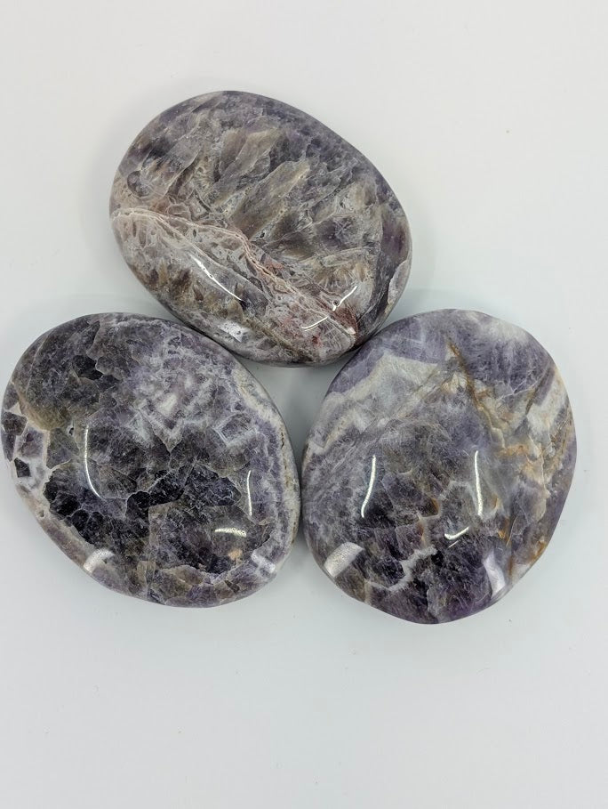 Overhead photo showing color zoning and smooth polish of Dream Amethyst Palm Stones