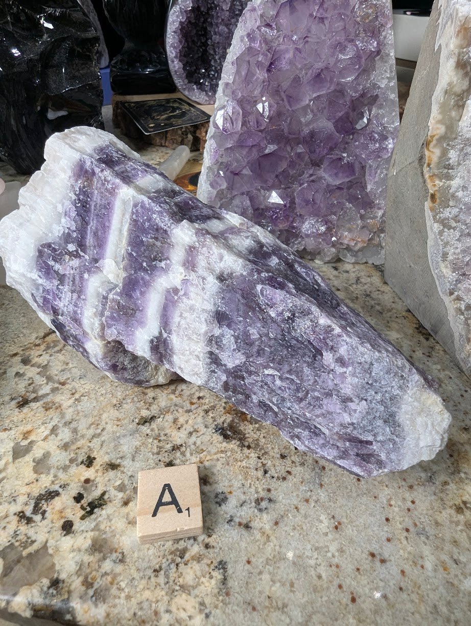 Large raw Dream Amethyst form, showing thick alternating bands of deep purple and white quartz.