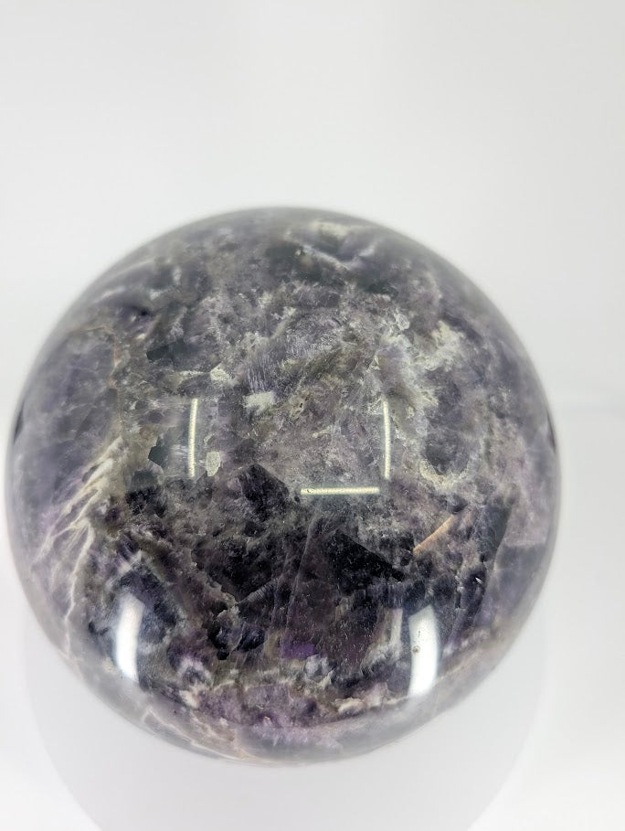 Dream Amethyst sphere showing deep purple tones and smooth mirror polish