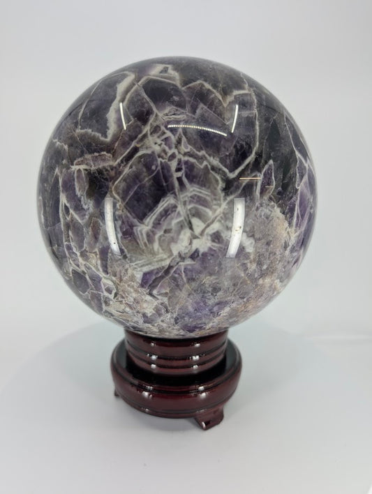 Dream Amethyst sphere showing deep violet chevron bands and polished surface