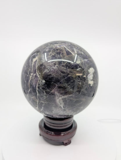 Side view of Dream Amethyst sphere highlighting quartz layering and violet banding