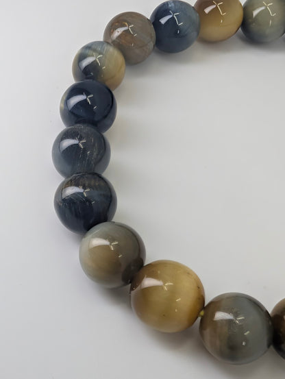 Detail of natural mixed Tiger’s Eye beads with strong chatoyant shimmer