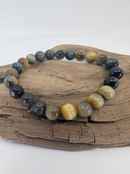 Dream Tiger’s Eye bracelet with 8mm beads displayed on driftwood