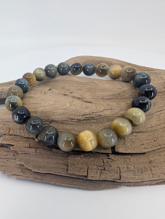 Dream Tiger’s Eye bracelet with 8mm beads displayed on driftwood