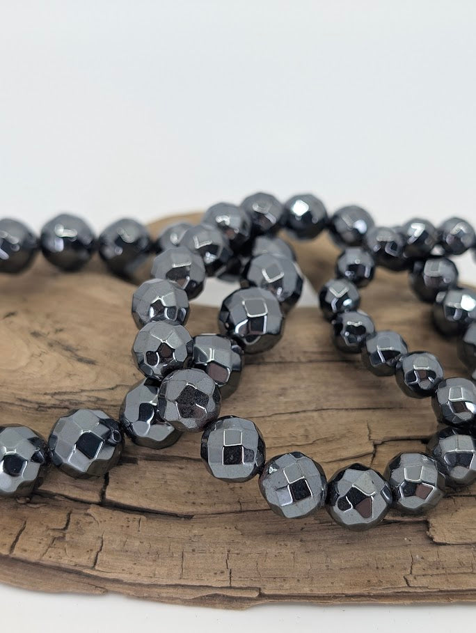 Close-up of faceted hematite beads showing mirror-like reflection
