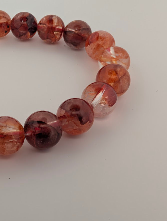 Detail of Fire Quartz bracelet highlighting fiery inclusions and glassy clarity