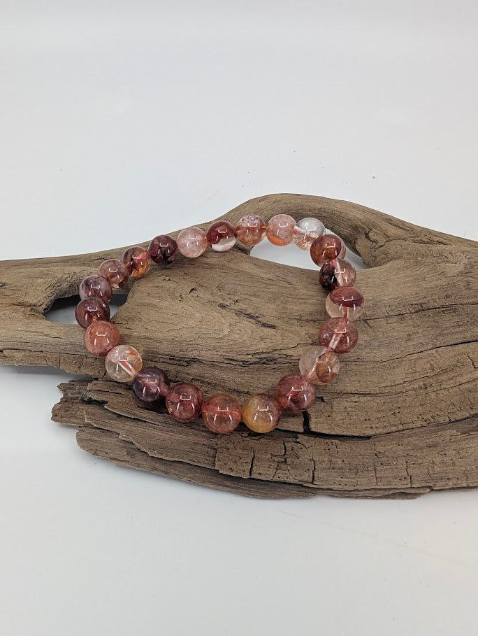 High quality Fire Quartz 8mm bracelet showing clear quartz with red hematite inclusions