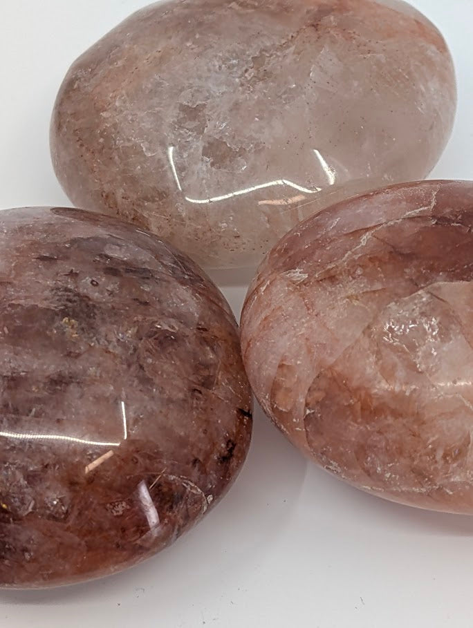 Close-up of Fire Quartz Palm Stone highlighting internal inclusions and polish detail