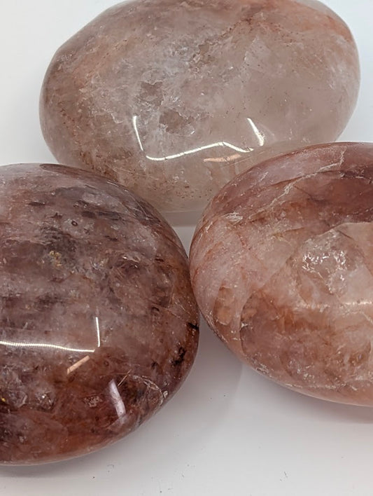 Close-up of Fire Quartz Palm Stone highlighting internal inclusions and polish detail