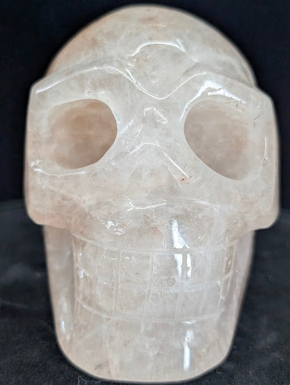 Fire Quartz (Hematoid Quartz) skull, front view showing translucent body and hematite veils