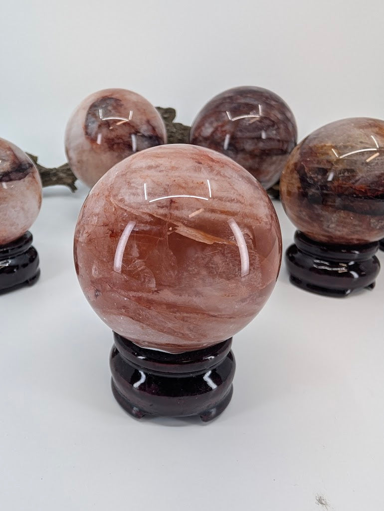 Clear front alignment showcase of polished Brazilian Hematoid Quartz sphere FQ-11, detailing the dense crimson and maroon layers.