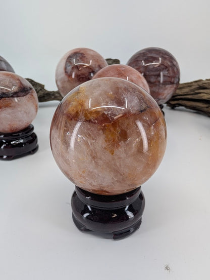 Clear front alignment showcase of polished Brazilian Hematoid Quartz sphere FQ-12, highlighting the bold golden-yellow limonite saturation.
