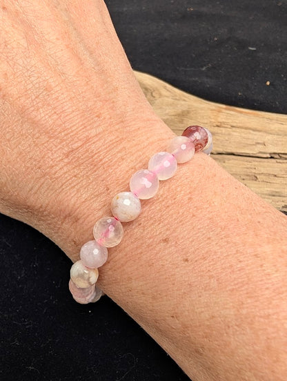 8mm faceted Flower Agate beaded stretch bracelet worn on a wrist for size scale.