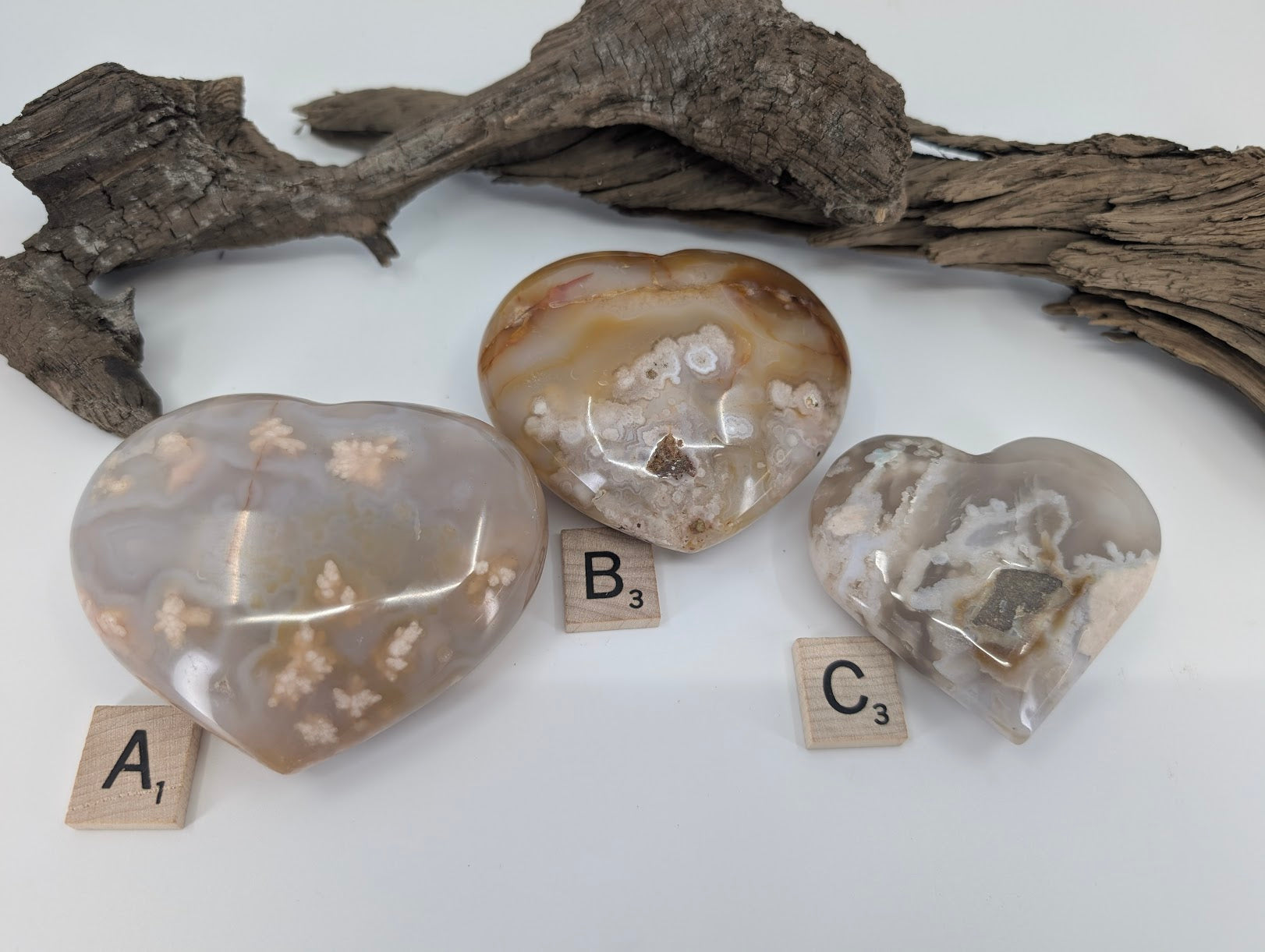 Group of three Flower Agate hearts labeled A, B, and C showing blossom patterns.