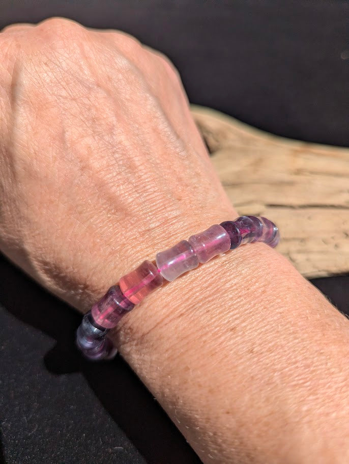 7mm polished Fluorite bamboo bead stretch bracelet worn on a wrist for size scale.