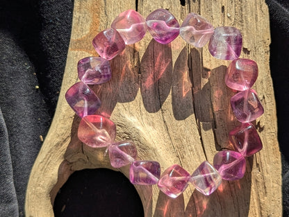 Alternate display angle of the 10mm Banded Purple Fluorite bracelet, emphasizing the high-gloss polish and internal light refraction of the calcium fluoride matrix.