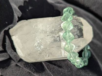 Premium 11.5mm Green Fluorite beaded stretch bracelet worn on the wrist to demonstrate its 17cm circumference scale and bold modern aesthetic.