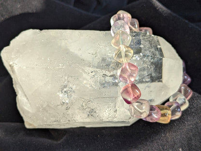 Premium 9mm Pastel Rainbow Fluorite beaded stretch bracelet worn on the wrist to demonstrate its 17cm circumference scale and elegant profile.