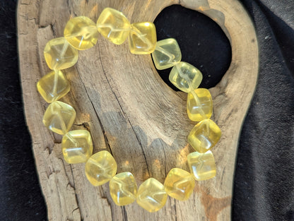 Detailed view of the 11mm Yellow Fluorite stretch bracelet, emphasizing the un-stabilized natural yellow colour profile.