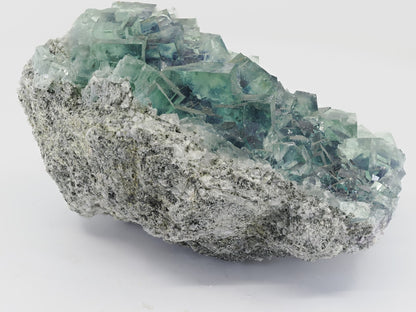 Side view of Zhejiang fluorite specimen showing the pale, granular host rock matrix.