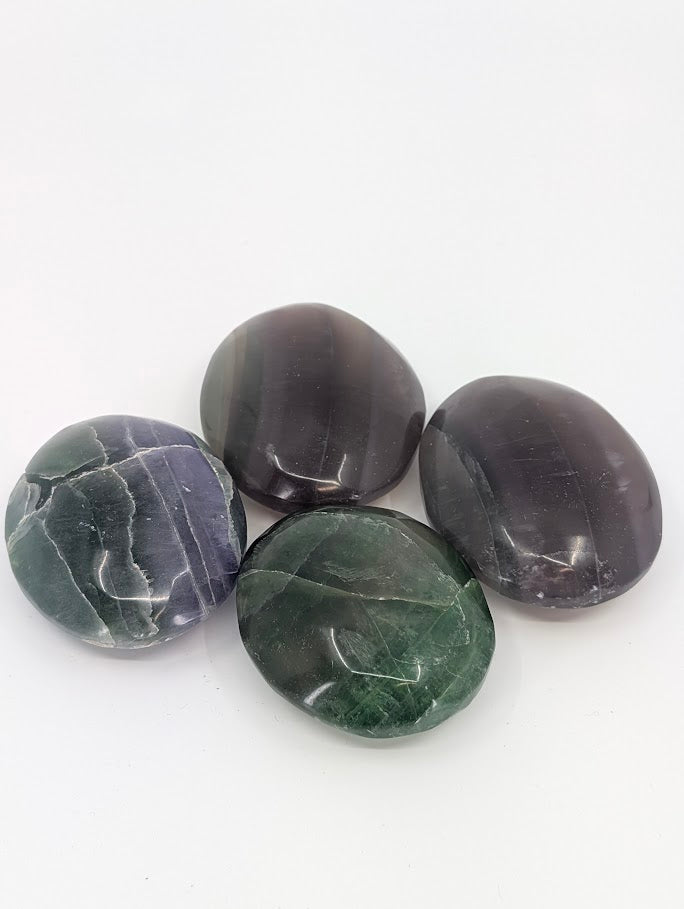 Fluorite Palm Stones showing green and purple color banding
