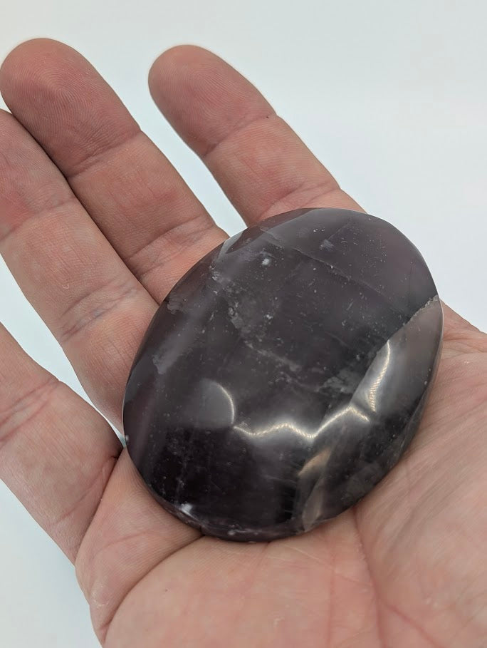 Fluorite Palm Stone in hand showing polish and color clarity