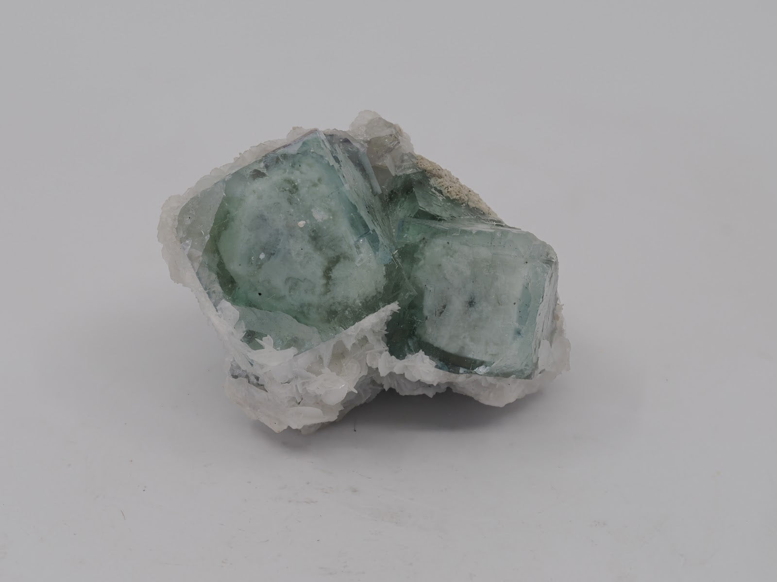 Front view of a 3.5cm Yaogangxian Porcelain Fluorite specimen showing blocky cubic structure and white bladed barite.