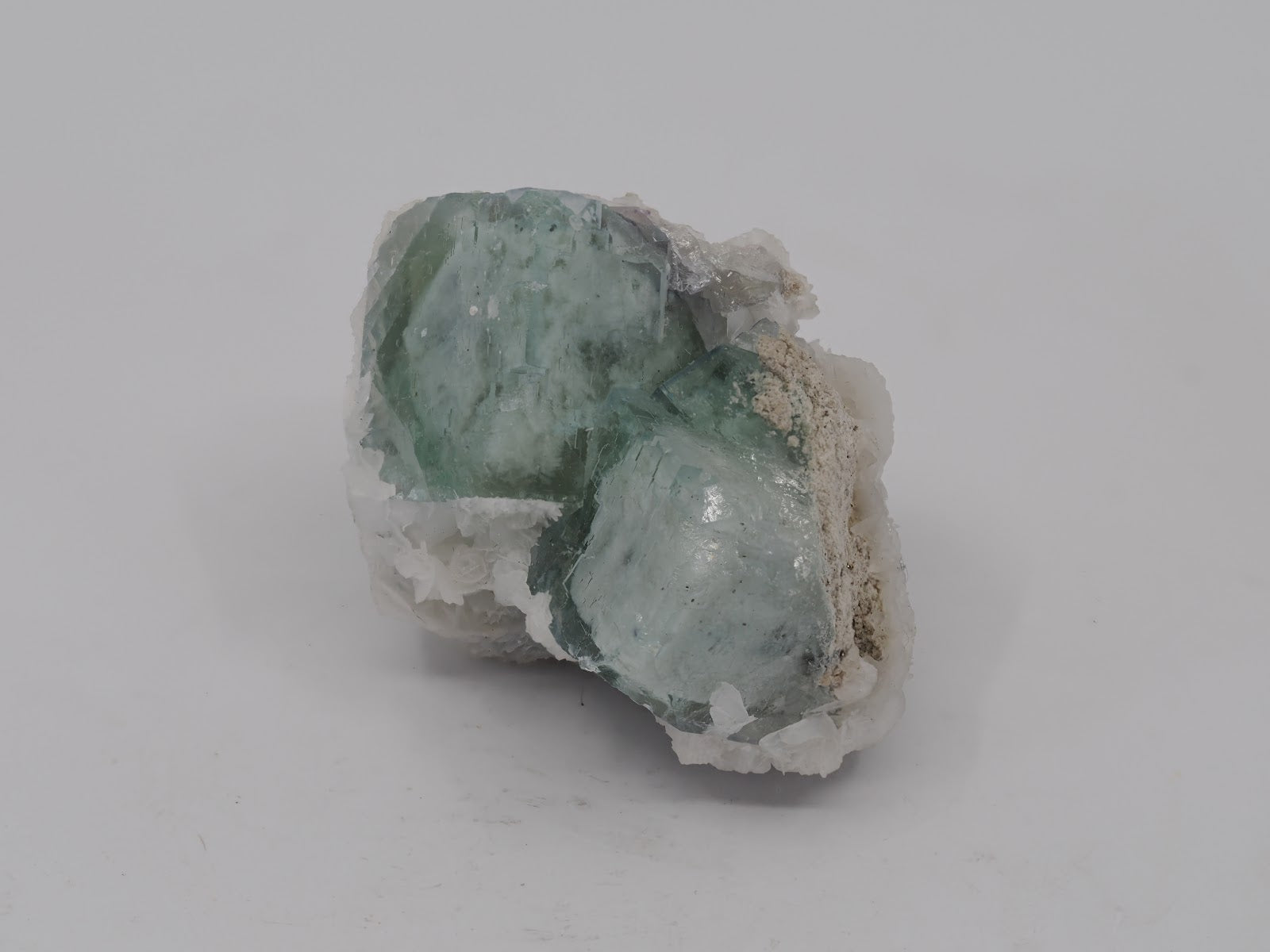 Top-down view of Porcelain Fluorite cubes on matrix showcasing waxy celadon color and isometric cubic symmetry.