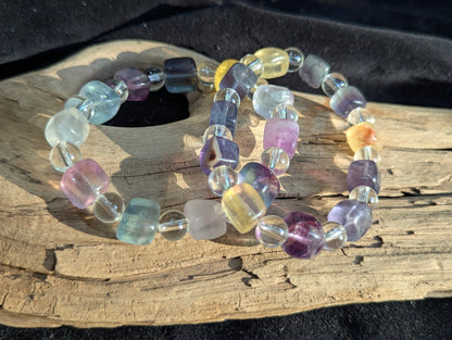 A selection of premium fluorite and quartz mixed-cut bracelets displayed together, showcasing the structural consistency and rich colour saturation across the intuitive selection lot.
