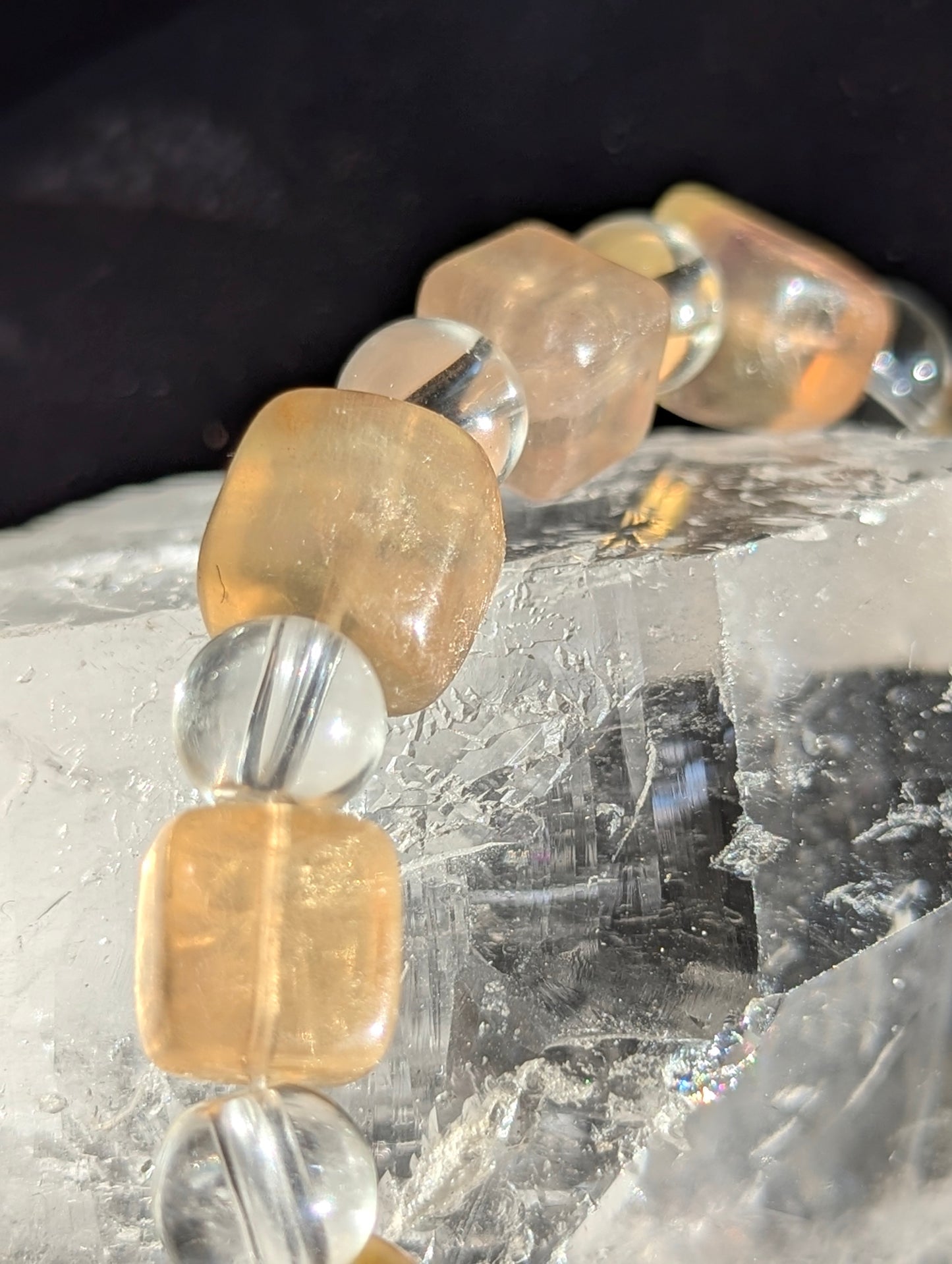 Macro detail of 9 mm yellow fluorite lapidary cubes interspersed with 8 mm clear quartz rounds, emphasizing the un-stabilized, all-natural internal mineral structure.