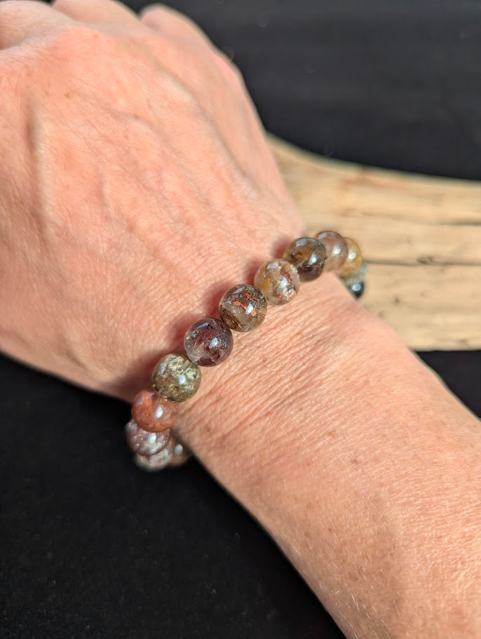 10mm AA Grade Four Season Garden Quartz beaded stretch bracelet worn on a wrist for scale.