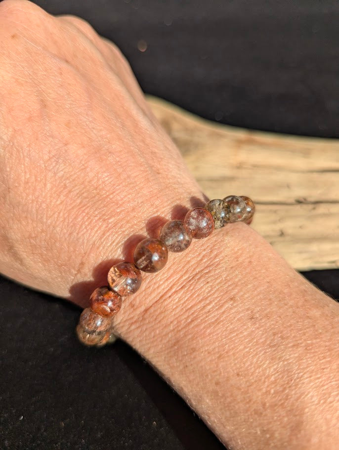 9mm AA Grade Four Season Garden Quartz beaded stretch bracelet worn on a wrist in natural sunlight.