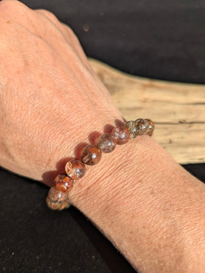 9mm AA Grade Four Season Garden Quartz beaded stretch bracelet worn on a wrist in natural sunlight.