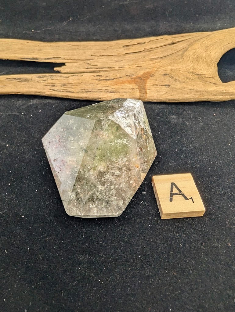 Angled view of exact piece Garden Quartz faceted freeform, Variant A1, highlighting the layered inclusions.