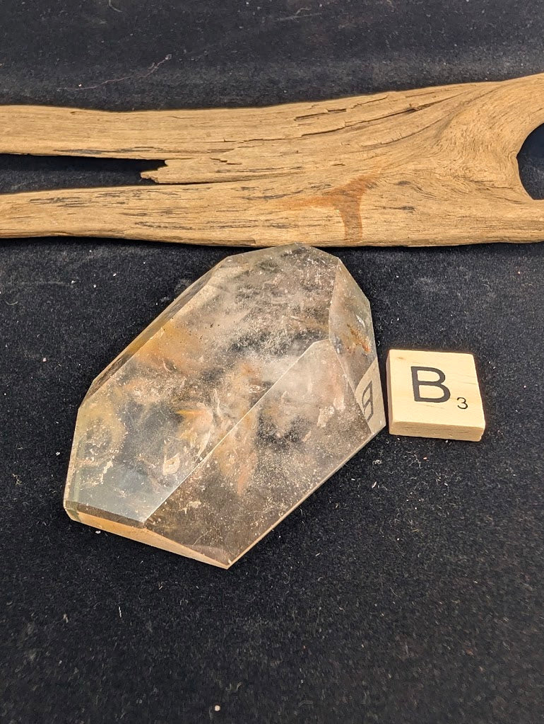 Exact piece Garden Quartz faceted freeform, Variant B3, featuring a concentrated internal landscape with yellow limonite staining and dark minerals.