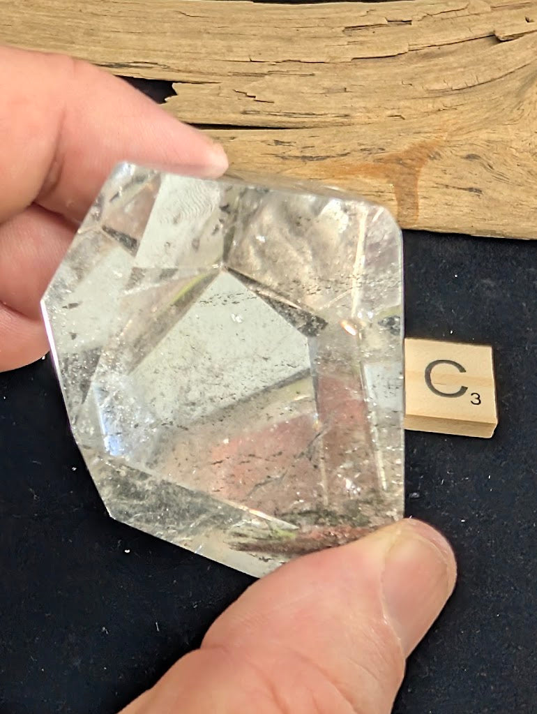 Reverse view of exact piece Garden Quartz faceted freeform, Variant C3, showing the base mineral deposits.