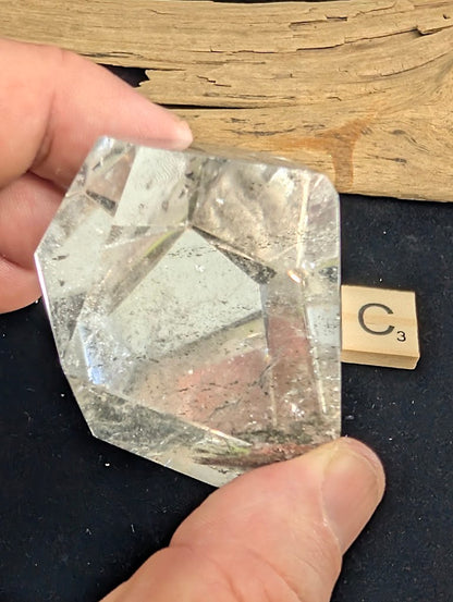 Reverse view of exact piece Garden Quartz faceted freeform, Variant C3, showing the base mineral deposits.